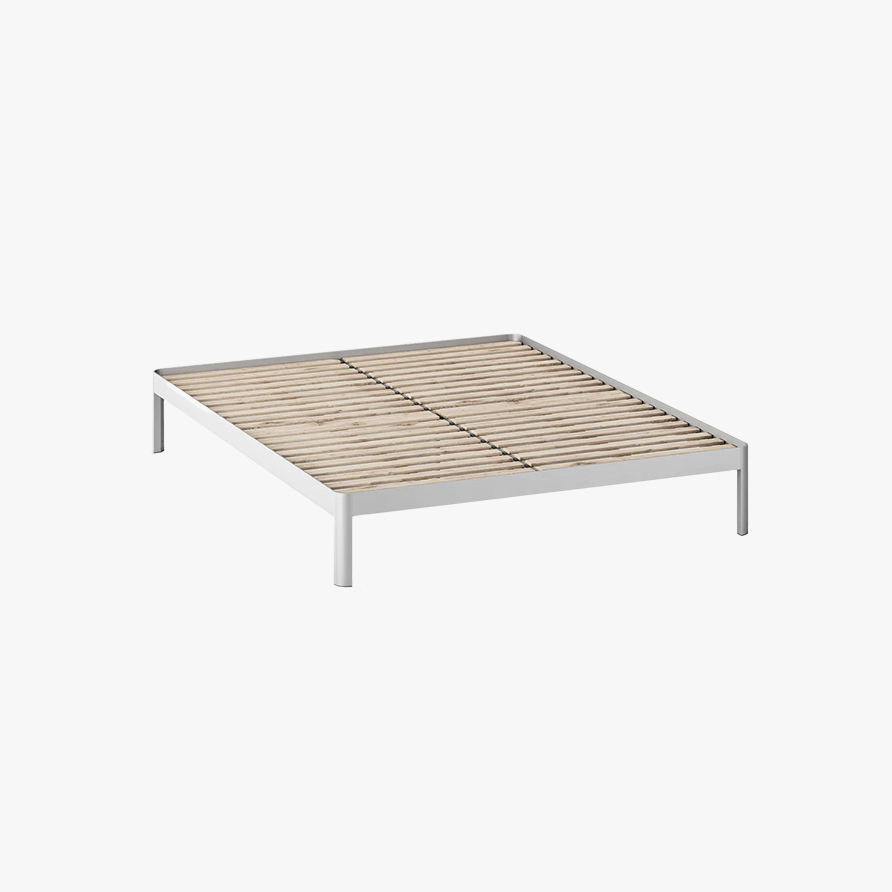 A white minimalist bed frame made from anodized aluminum and supports wooden slats