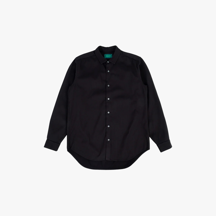 A loose-fitting black shirt with ribbed texture with silver-ish buttons and a green label that says “OMEN” in the neck area
